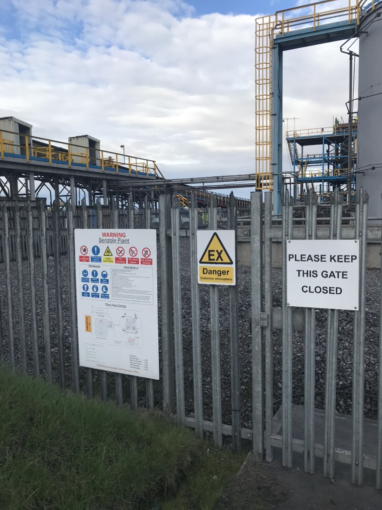 Hazardous-area warning signage at a site gate